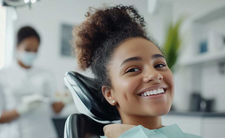 Adult patient reviewing clear aligner trays with a dental professional in a bright treatment room.